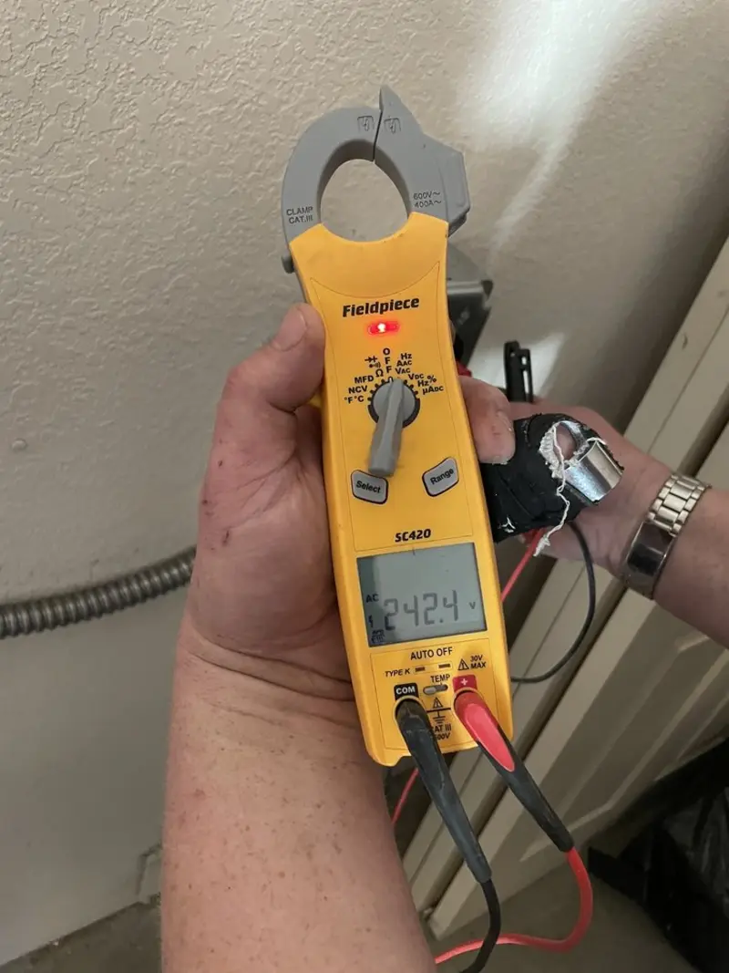 Voltage testing with clamp meter during Generator Installation in Florida Gulf Coast University